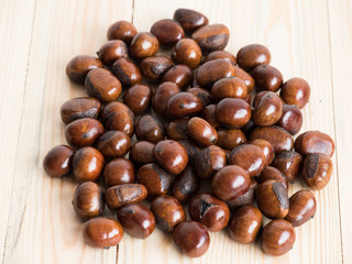 fresh chestnuts on wooden background