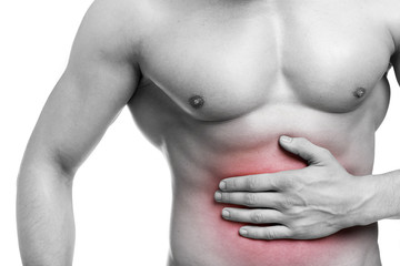 Naklejka premium Fit man with stomach pain, isolated on white background
