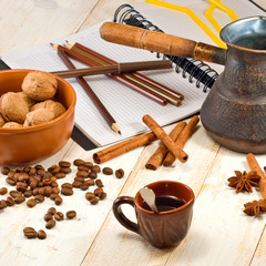 image of a cup of coffee, coffee beans and nuts in a bowl closeup