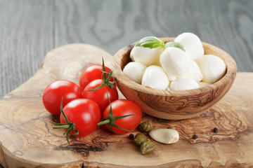 Tomato and mozzarella with basil leaves in bow