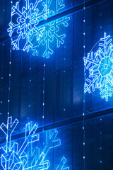 Christmas lights decoration on a building facade in blue tone