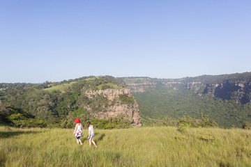 Girls Hiking Wilderness footpath trail rural landscape summer.