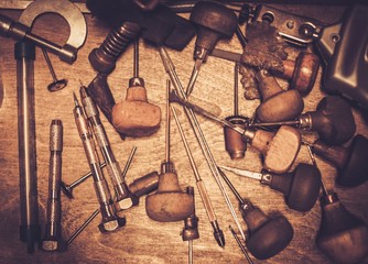 Different goldsmiths tools on the goldsmith workplace.
