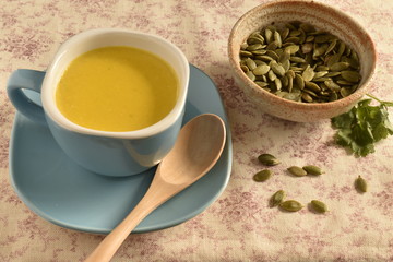 Pumpkin soup in a blue bowl