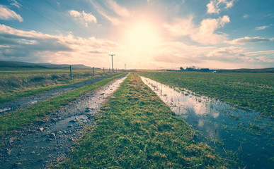 The sun setting over a remote farm. The image has added grain and styling. © Duncan Andison