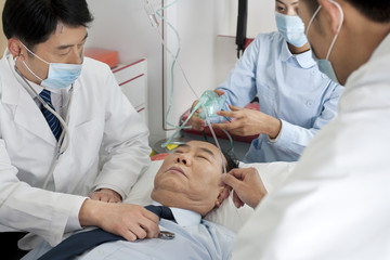 Medics treating a patient in an ambulance © Blue Jean Images