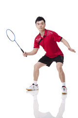 Male athlete playing badminton
