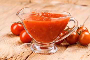 whole and crushed tomatoes on wooden board