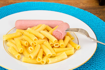 Eating Fast Food: Pasta with Sausage on Plate