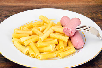 Eating Fast Food: Pasta with Sausage on Plate