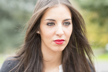 Naklejka premium Portrait of young woman with green eyes and makeup.