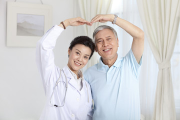 Doctor and patient doing a heart shape gesture