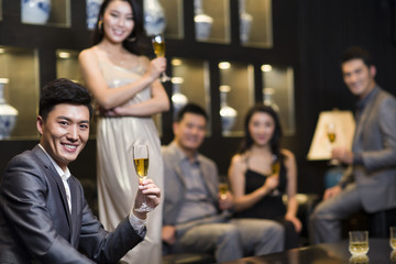 Cheerful adults drinking alcohol in luxury club