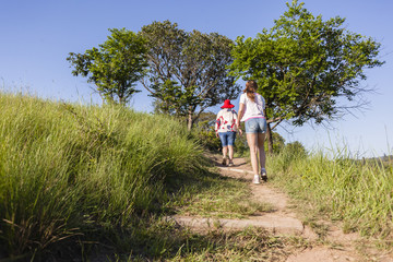 Girls Hiking Wilderness footpath trail rural landscape summer.