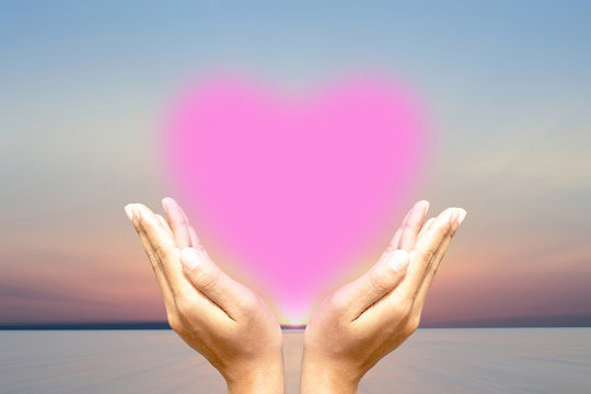 Human hands protect the heart Sky background