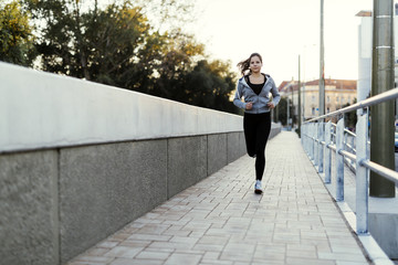 Fototapeta na wymiar Sporty woman jogging in city