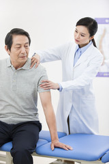 Fototapeta premium Female doctor examining senior patient