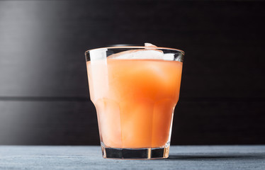 Grapefruit beverage on the wooden background