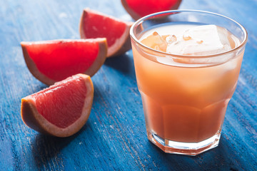 Grapefruit beverage on the wooden background