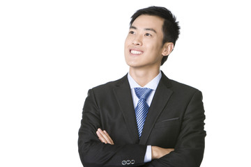 Young businessman looking up and smiling