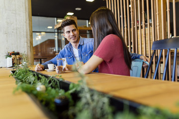 Happy young couple in restaurant