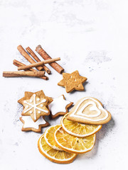 Group of cookies and cinnamon stiks on white stone background.