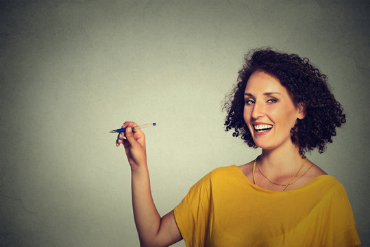 Young happy woman drawing writing on board with empty blank copy space