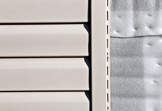 Installation on facade panels beige vinyl siding