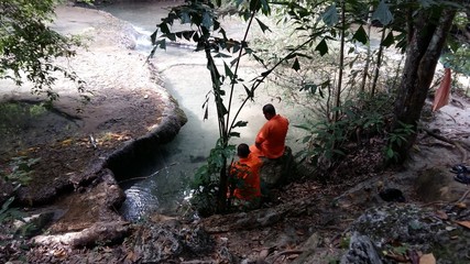 Monks near the water in Asia