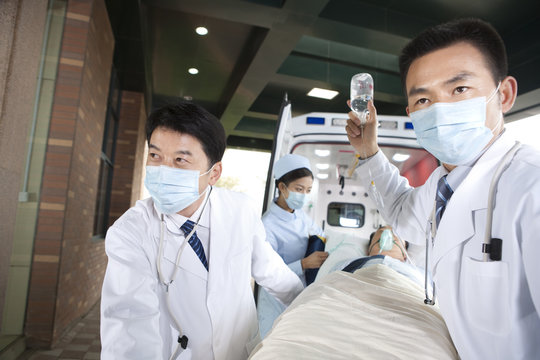 Medics moving a patient from an ambulance