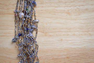 necklace on a wooden background with copy space