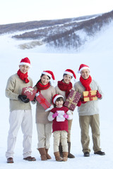 Fototapeta na wymiar Happy family holding Christmas gifts