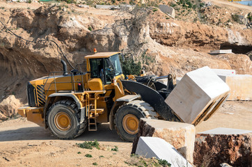 Marble quarry Industrial / Industrial marble quarry, with cut blocks and workers and machines bulldozer at work.
