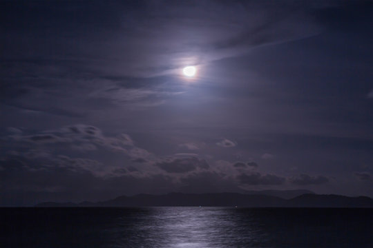 Full moon with clouds and sky over the sea