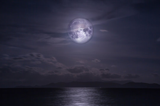 Full moon over the sea. Elements of this image furnished by NASA