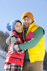 Fototapeta na wymiar Happy young couple in ski resort