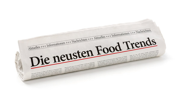 Zeitungsrolle mit der Überschrift Die neusten Food Trends