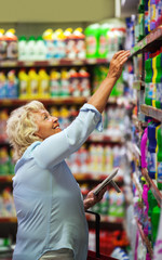 Woman buying household detergents in the shop