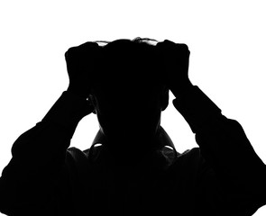 A young man with grief tearing at her hair with both hands