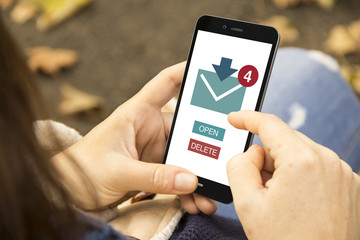 woman with e-mail phone in the park