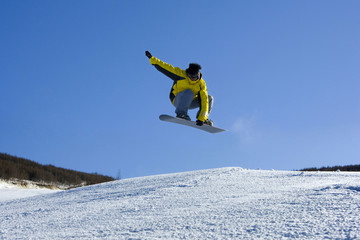 A young man snowboarding