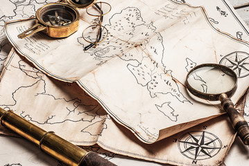 An old brass compass on map background