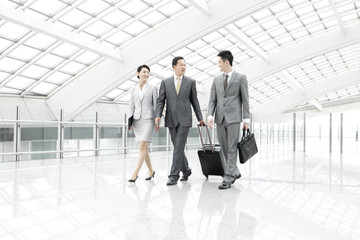 Business partners on the move in airport lobby