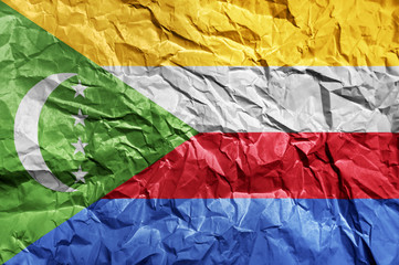 Comoros flag painted on crumpled paper background