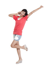 Studio shot of a happy young woman talking on a cell phone