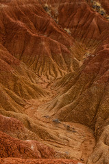 Dry valley red orange sand stone rock formation in hot desert of Tatacoa, Huila