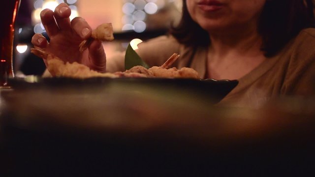 Woman in a restaurant eating sea food