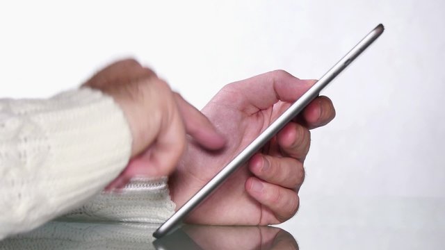 Young Boy Browsing a Tablet Computer.
Man using iPad tablet computer touch screen.
Two hands browse and touch tablet screen.
A businessman looking on line and browsing applications.
