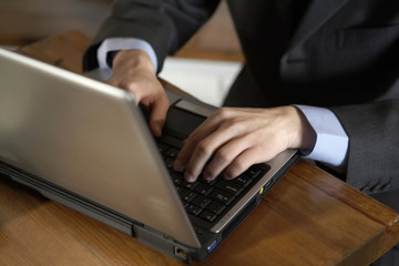 Man Typing On Laptop Computer