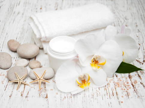 spa essentials cream white towels and orchids